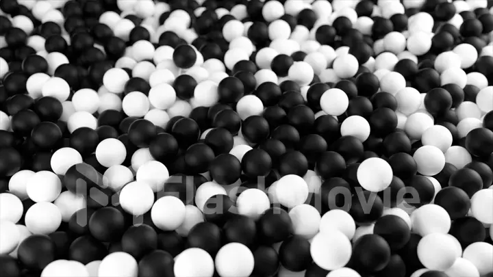 Black white 3D illustration from a pile of abstract spheres and balls rolling and falling from top to bottom.