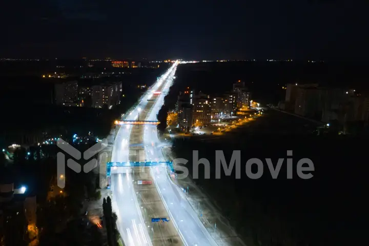 Hyperlapse timelapse of night city traffic fast cars driving around on the highway. Aerial view