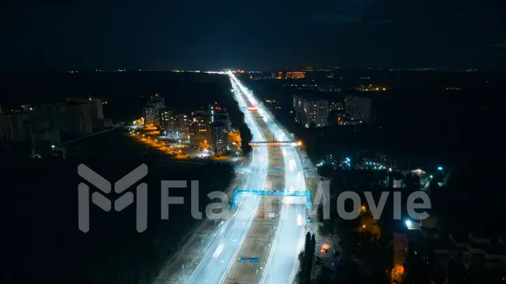 Hyperlapse timelapse of night city traffic fast cars driving around on the highway. Aerial view