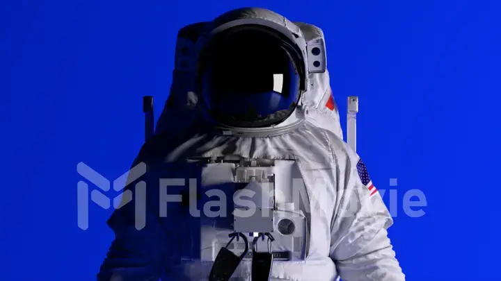 The head of an astronaut on a blue background. Lighting is changing. Helmet. Dark and light. Shadows on the wall
