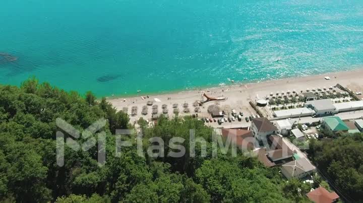 Aerial 4k view tropical beach with blue-green sea, green mountains of the rainforest. Secluded hidden beach in paradise. Blue sky, turquoise calm ocean waves of water.