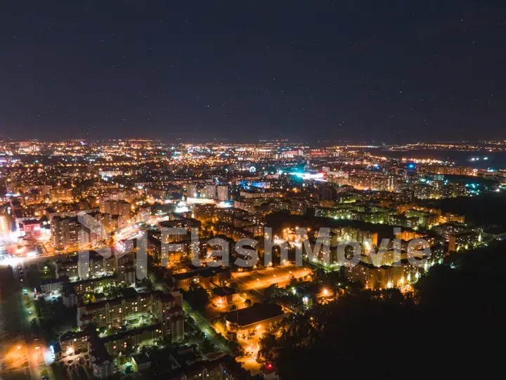 Night city under the starry sky. Bright city lights. Milky Way