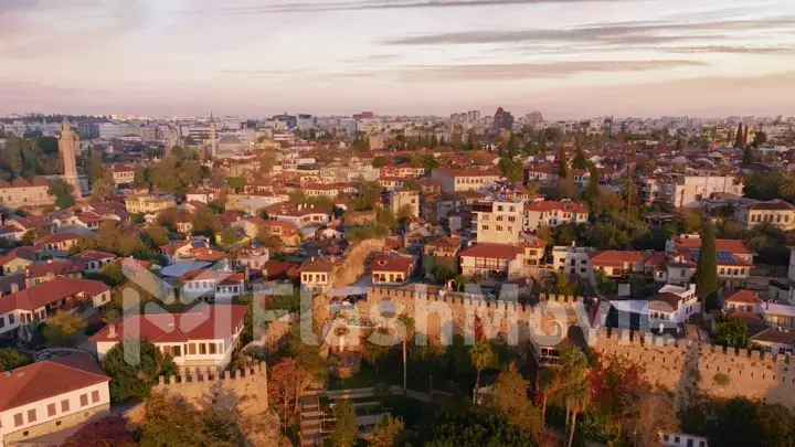 View over the red roofs and medieval wall of the old city. Sunset. Panorama. Aerial drone view