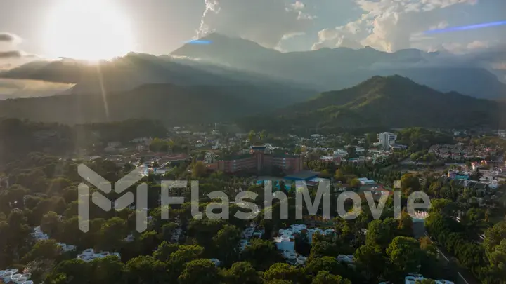 Sunbeams through the clouds. Sunset. Aerial drone view of resort town. Mountain landscape. Photography