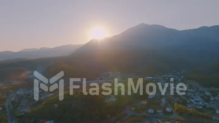 Beautiful landscape. Aerial view of the resort town. Sunset sky. Mountains in the background.