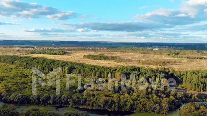 Flight in the beautiful countryside among a river of woods and fields near the city