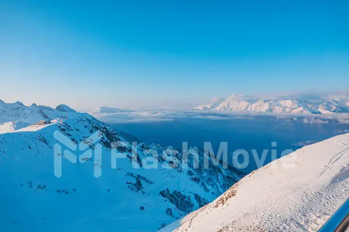 Alpine landscape of snow covered mountains and blue sky