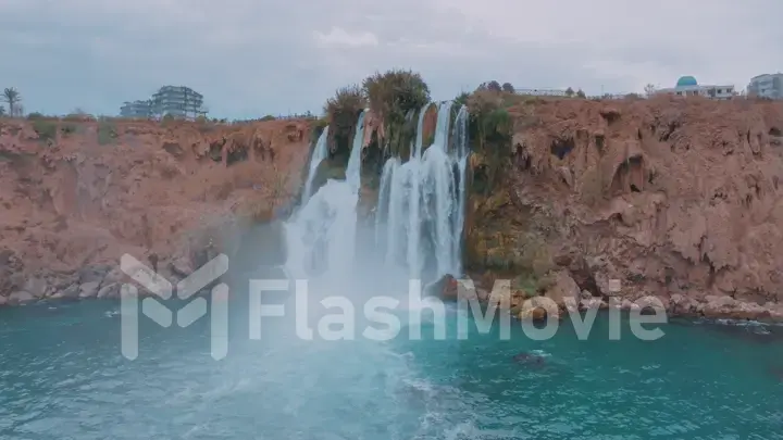 Beautiful stormy waterfall. Turquoise lagoon in a tourist place. Pure water. Aerial drone view