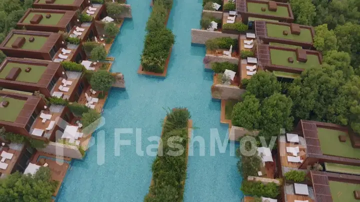 Aerial view of the hotel courtyard. Vacation at the resort. Green shrubs. Mountains in the background