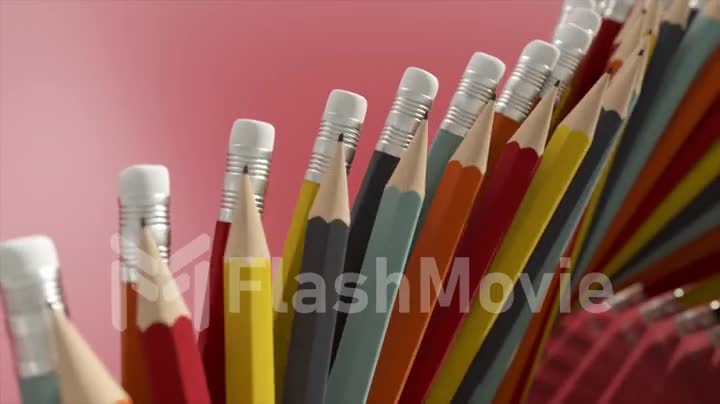 Ads concept. Stationery. Top view of pencils arranged vertically and moving along the conveyor. Eraser on a pencil