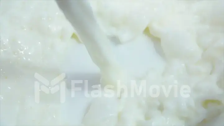 Pouring fresh milk into clean dishes in slow motion