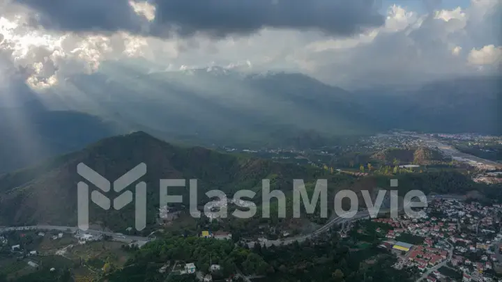 Sunbeams through the clouds. Aerial drone view of resort town. Mountain landscape. Photography