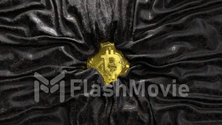 Satin black and gold fabric crinkles around the bitcoin. Cryptocurrency concept. Silk. Creases in fabric. Drapery.