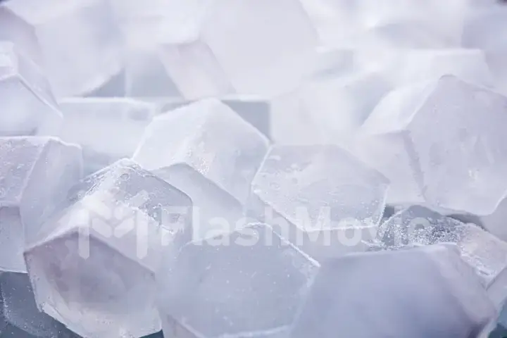 Macro shot of ice cubes from clear water that melt in slow motion on a white background. Concept: pure mountain spring water, ice, cocktails, fresh and frozen foods.