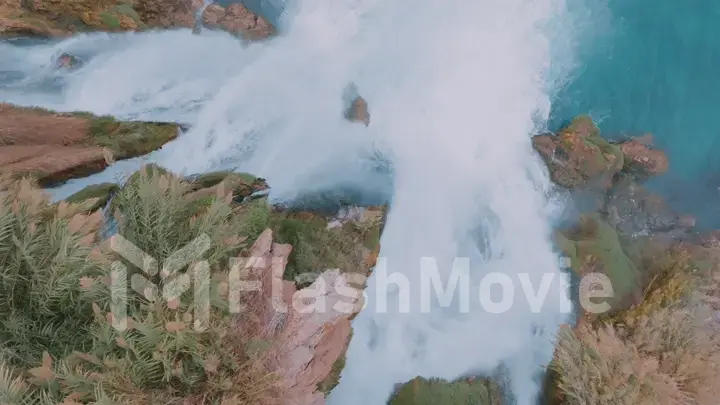 Beautiful stormy waterfall. Turquoise lagoon in a tourist place. Pure water. Aerial drone view