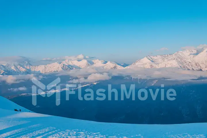 Alpine landscape of snow covered mountains and blue sky