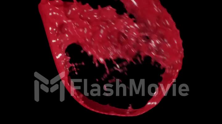 Pouring red wine in slow motion on black background
