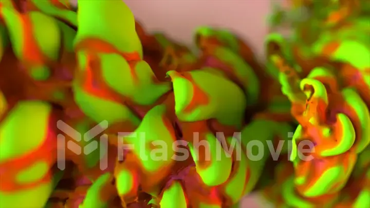 Abstract concept. Thick green red smoke moves and leaves a colored trail behind it. Close-up. Pink background.