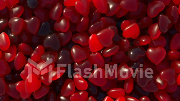 Valentine's Day. A red neon heart jumps out of a pile of dark blue hearts. Heart shaped gummies. Sweets.