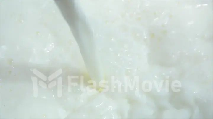 Pouring fresh milk into clean dishes in slow motion