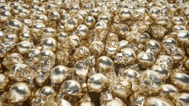 A bunch of golden skulls lie on top of each other. The concept of greed. Seamless loop 3d render
