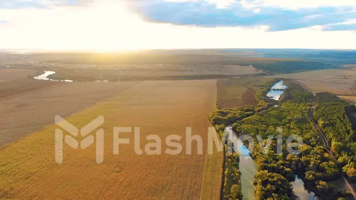 Flight in the beautiful countryside among a river of woods and fields near the city