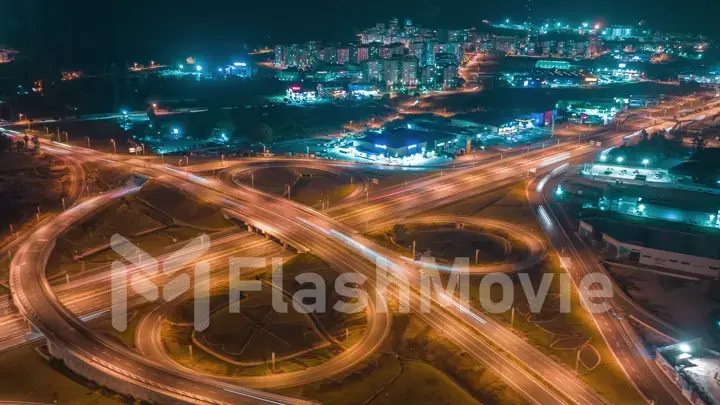 Flying around a multi-level stack interchange. Aerial drone view . Blue yellow light. Fast moving. Photography