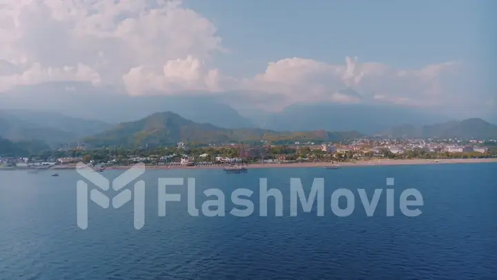 Panorama view of the blue sea. Beautiful clouds. Mountains in the background. Seascape. Photography