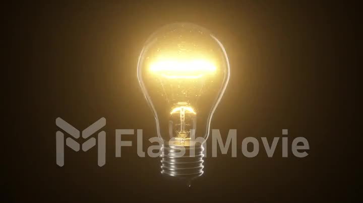 Flickering tungsten light bulb lamp over black isolated background