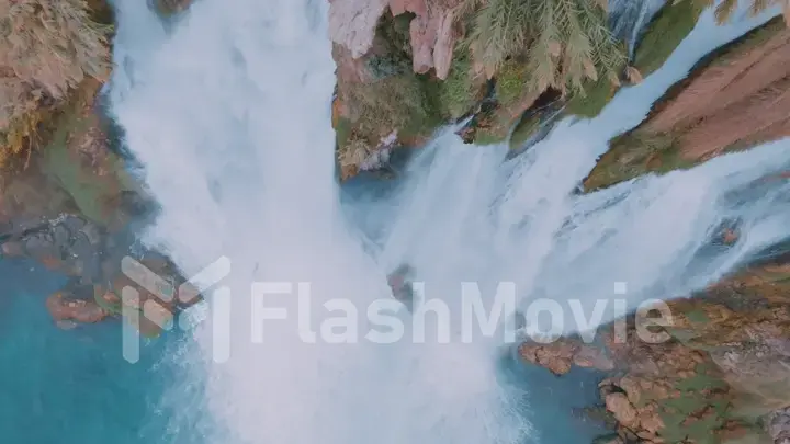 Aerial drone view of the waterfall, turquoise water and rocky shore. Wildlife. The element of water.