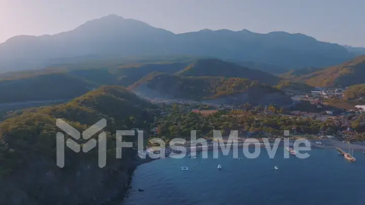 Seascapes shore at sunset. Panorama view of the blue bay against the backdrop of a mountain landscape.