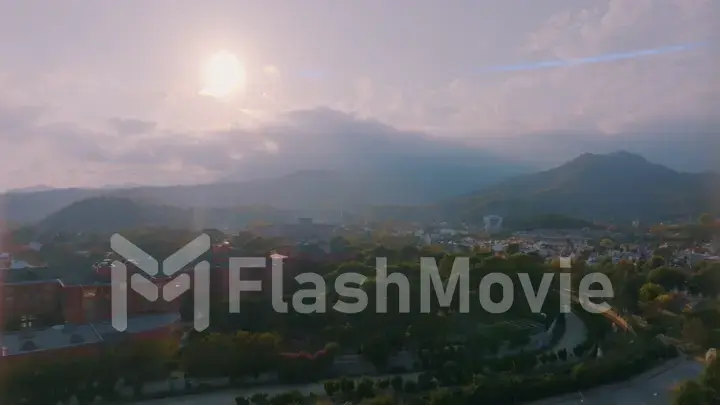 Beautiful landscape. Aerial view of the resort town. Sunset sky. Mountains in the background.