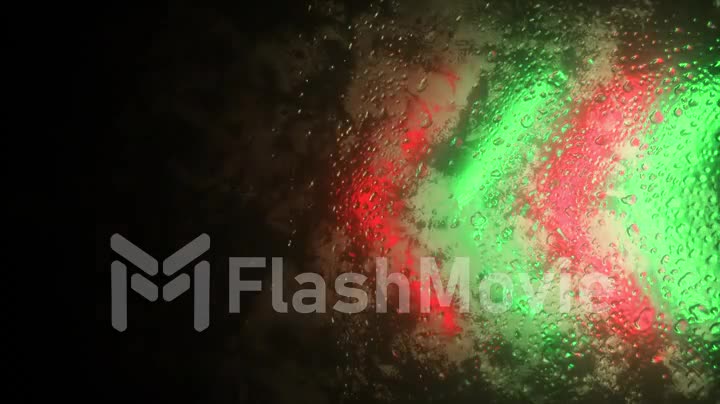 Bright neon arrows flash through a fogged window. Drop of water on the window. Seamless loop 3d render
