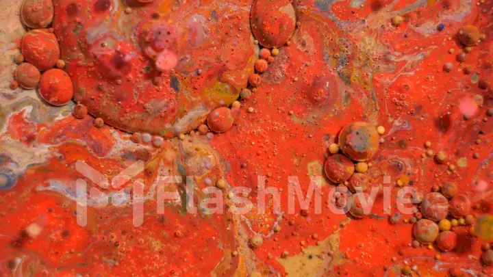 Bright colorful red bubbles on the surface of the water. Abstract paint bubbles