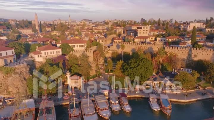 Top view from above on the roofs of houses, boats and yachts on the pier. Sunset. Seascape. Drone video footage.