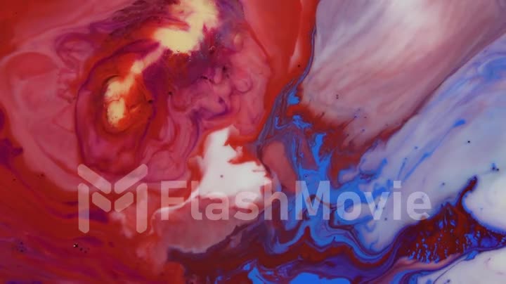 Bright colorful acrylic paints mix into abstract pigments in slow motion. Abstract color moving background close up macro