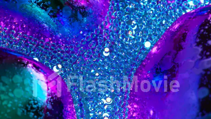 Abstract concept. A stream of glowing blue neon particles flows around gray metal bubbles. Close-up. Advertising
