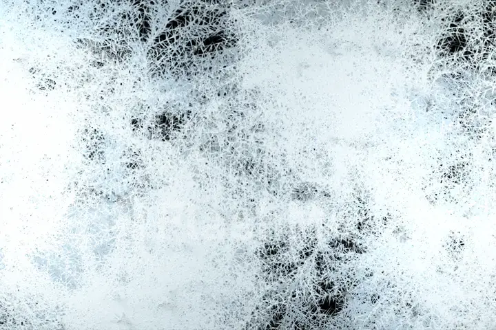 Beautiful freezing animation. Patterns of ice and frost spread to the screen on an isolated black background. 3d illustration