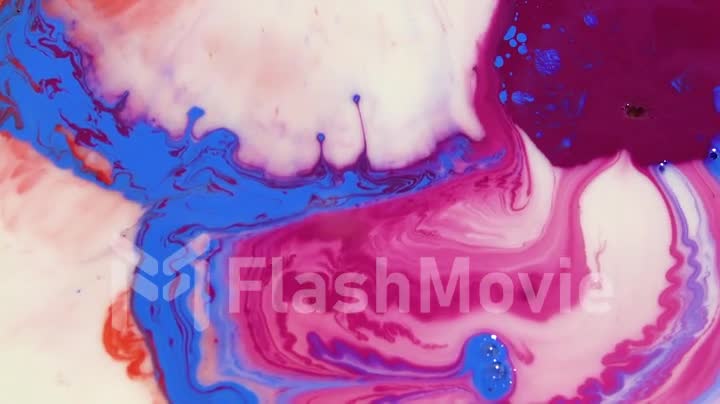 Liquid Colorful Paint pattens mix in slow motion. Liquid color paint patterns texture top view. Multicolor liquid paint surface.