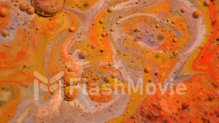 Bright colorful orange bubbles on the surface of the water. Abstract paint bubbles