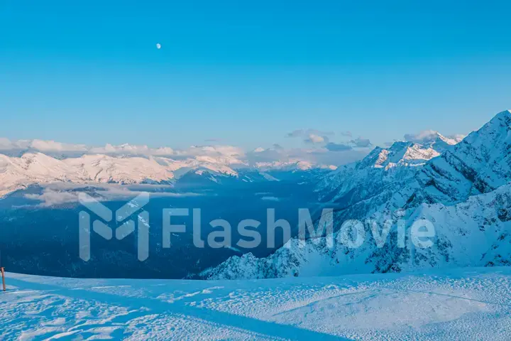 Alpine landscape of snow covered mountains and blue sky