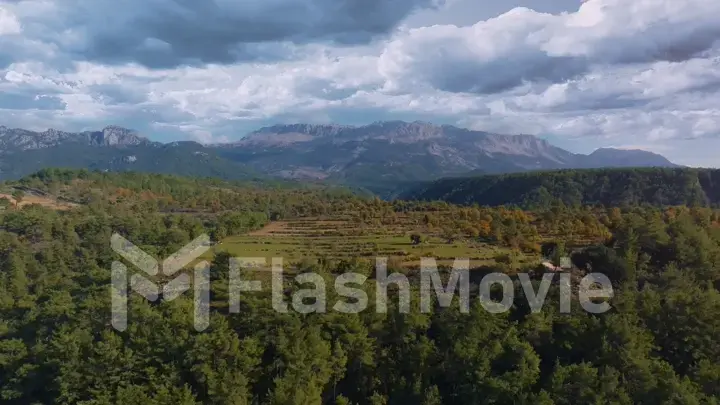Beautiful landscape. Top view of green hills and forests. Blue sky and clouds. Countryside. Wildlife. Aerial drone view