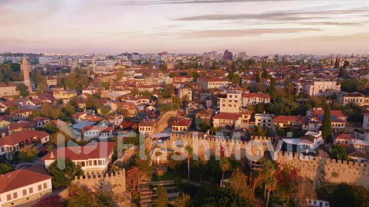 View over the red roofs and medieval wall of the old city. Sunset. Panorama. Aerial drone video footage.