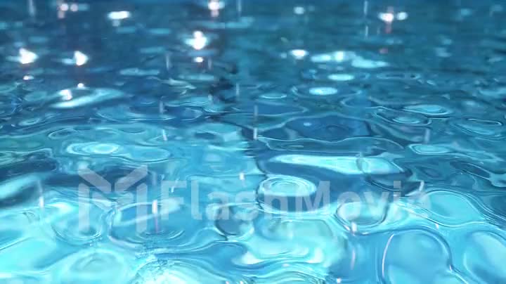 Pure blue water in the pool with light reflections
