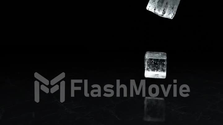 Two falling ice cubes on a textural surface in slow motion