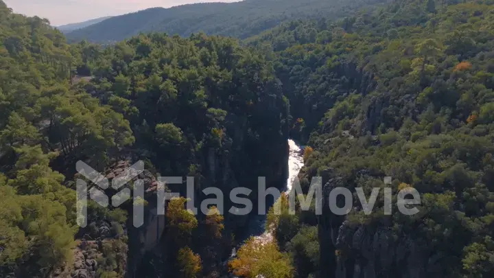 Top view of shallow river bed between green rocks. Mountain landscape. Wildlife. Tourism. Ecology