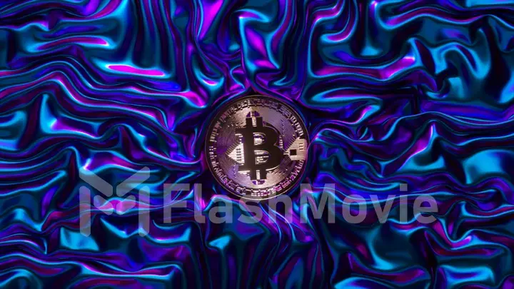 A fabric of metallic neon blue is wrinkled around the bitcoin. Shiny fabric. Cryptocurrency. Creases in fabric. Drapery
