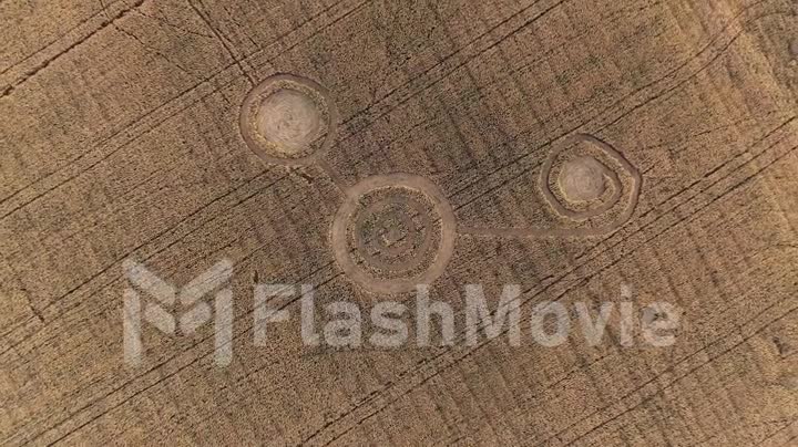 Mysterious mystical geometric signs in the middle of a wheat field. UFO left footprints in the field. Aerial 4k footage