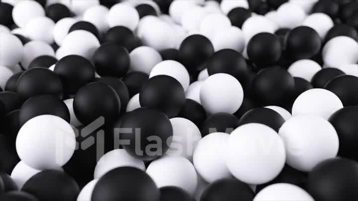 Black white 4k 3D animation from a pile of abstract spheres and balls rolling and falling from top to bottom.