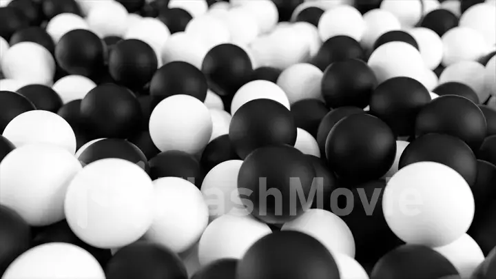 Black white 3D illustration from a pile of abstract spheres and balls rolling and falling from top to bottom.